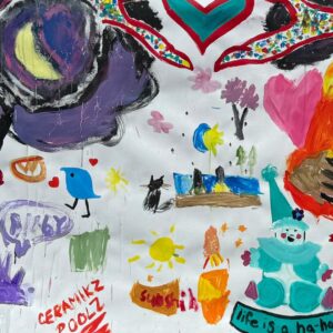 Colorful mural of playful, childlike paintings featuring hearts, animals, suns, and imaginative shapes.