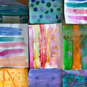 Grid of colorful abstract watercolor paintings with stripes, shapes, and blended hues.